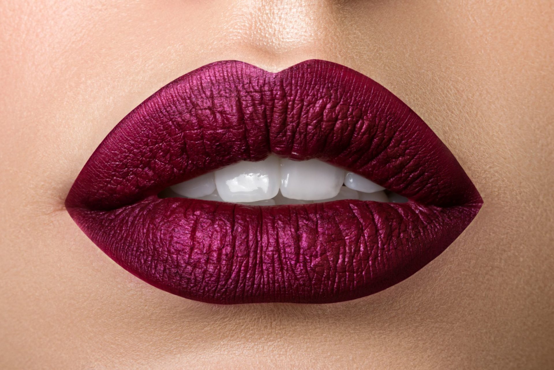 Close up view of beautiful woman lips with purple matt lipstick